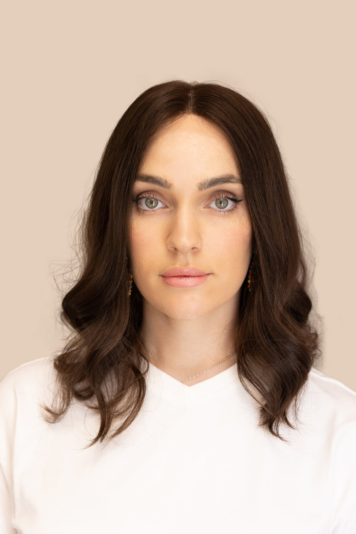 Woman wearing a natural human hair wig with face-framing layers, fitted at Dorin Wigs in Fort Lauderdale